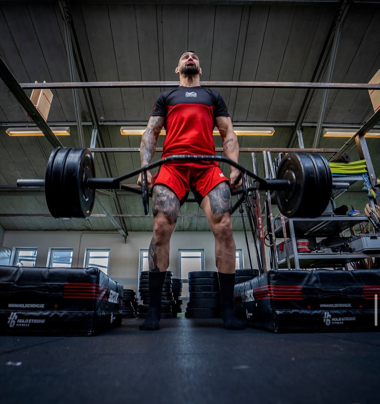 UFC- & MMA-Fighter Aleksandar "Rocket" Rakic mit Phantom Athletics Rashuard und Training Shorts beim Krafttraining