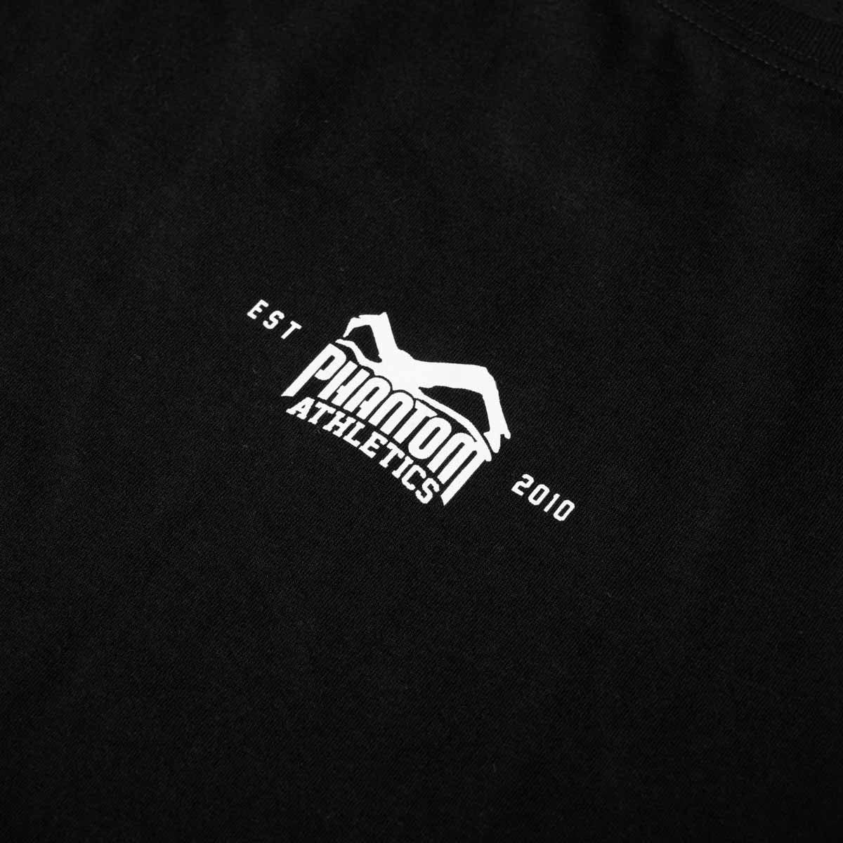 Das Phantom Athletics T-Shirt Core überzeugt mit schwarzem Design, kleinem Core-Print und hochwertigen Label-Details an Saum und Ärmeln. Die sportliche Kampfsportbekleidung eignet sich für Boxen, MMA, Muay Thai, Krafttraining sowie als lässige Fightwear in der Freizeit.