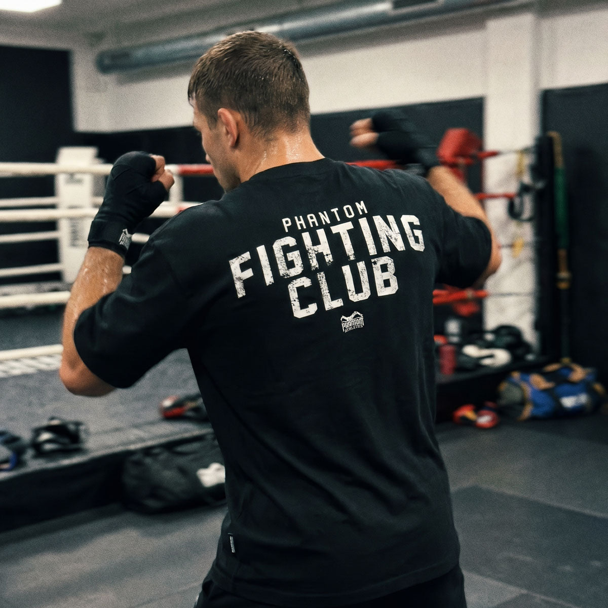 Mit dem Phantom Athletics Oversize Shirt Fighting Club erhältst du ein vielseitiges Kampfsport T-Shirt für Training und Alltag. Der hochwertige Baumwollmix sorgt für Komfort, während der Oversize Schnitt optimale Performance im Gym ermöglicht.