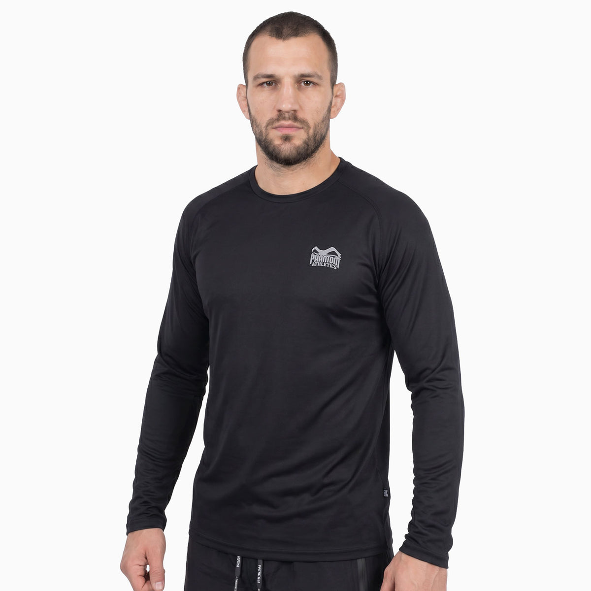Das Phantom Athletics Trainingsshirt TACTIC V Langarm in Schwarz kombiniert atmungsaktives Performance-Material mit einer sportlichen Passform für maximale Bewegungsfreiheit. Die hochwertige Kampfsportbekleidung eignet sich ideal für MMA, Boxen, Kickboxen, Muay Thai, Grappling und intensive Trainingseinheiten im Gym.