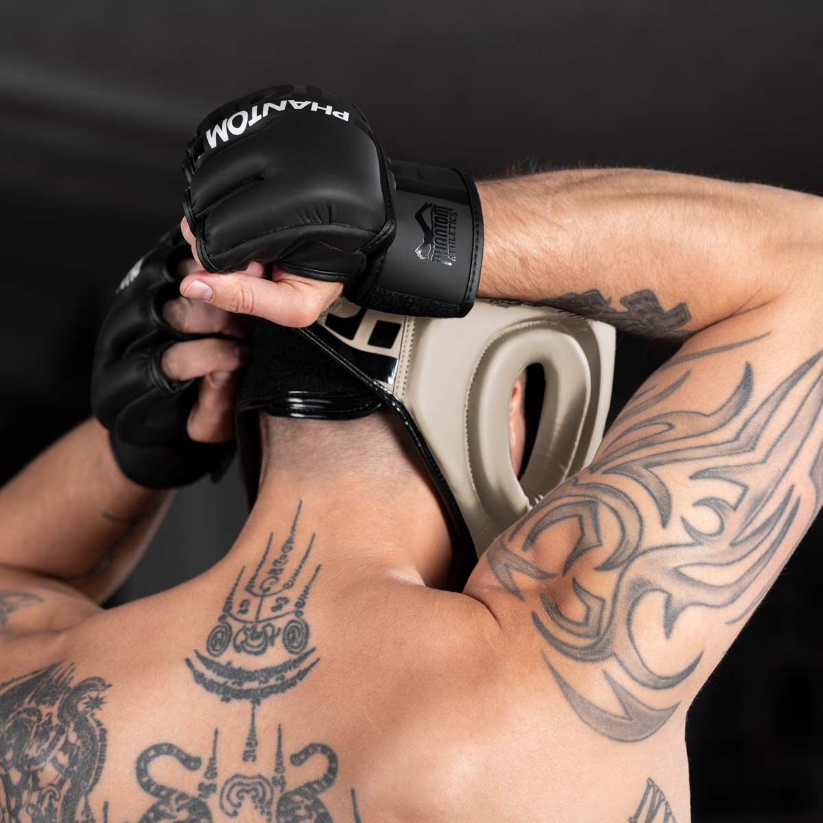 MMA Fighter schließt den Phantom APEX Full Face Kopfschutz in Sand an der Rückseite für sein nächstes Sparring